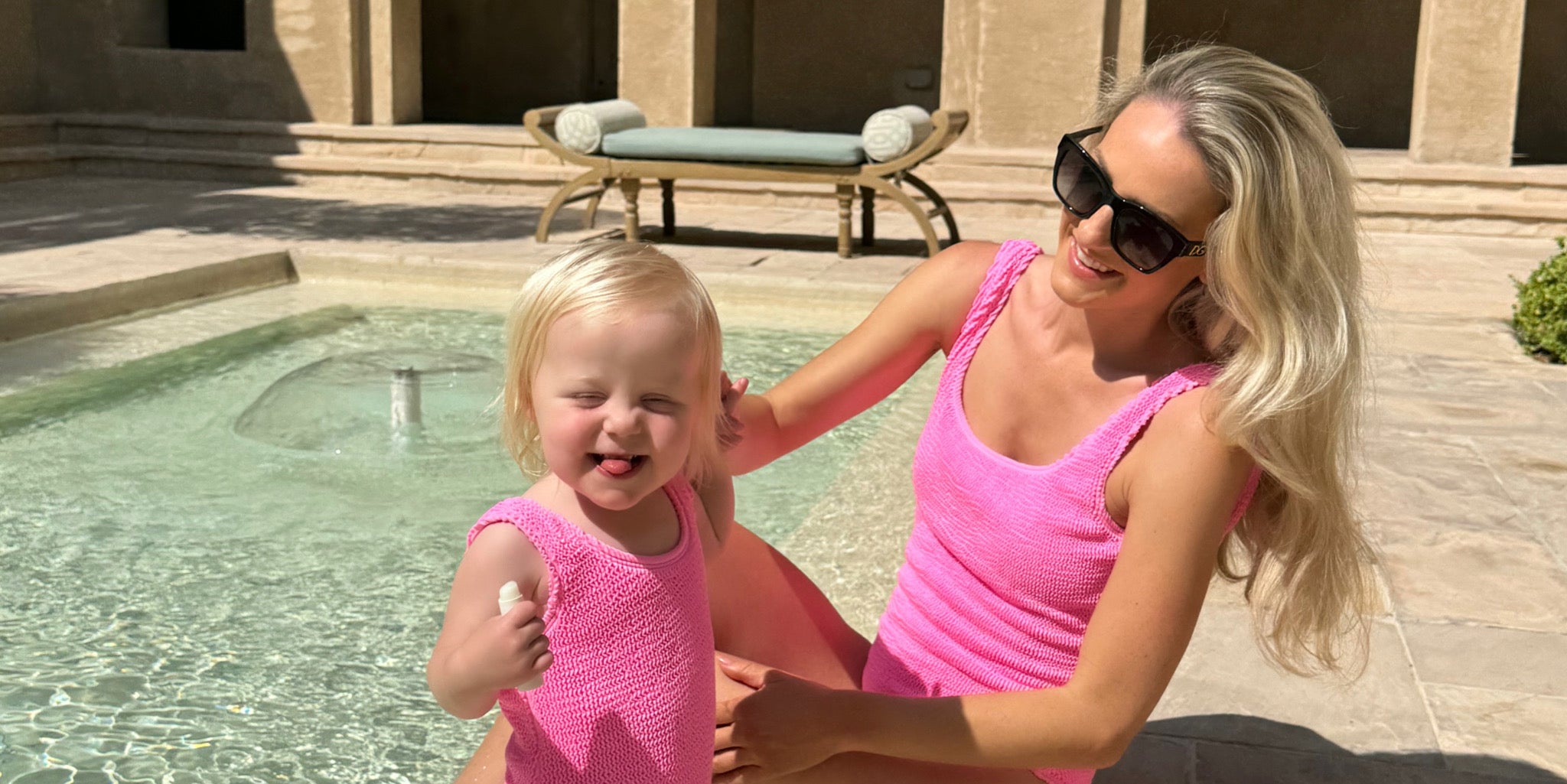 Mum and daughter matching in crinkle pink swimsuits