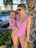 Mum and daughter wearing matching Aura purple swimsuits