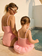 Tulla Crinkle Swimsuit in blush for adult and Tulla Crinkle Kids Swimsuit in blush, premium crinkle fabric, matching mum & daughter set at poolside