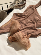 Close-up of the Muse swimsuit in mocha, showing sculpting crinkle fabric and soft ruffle 3 tier tutu detail