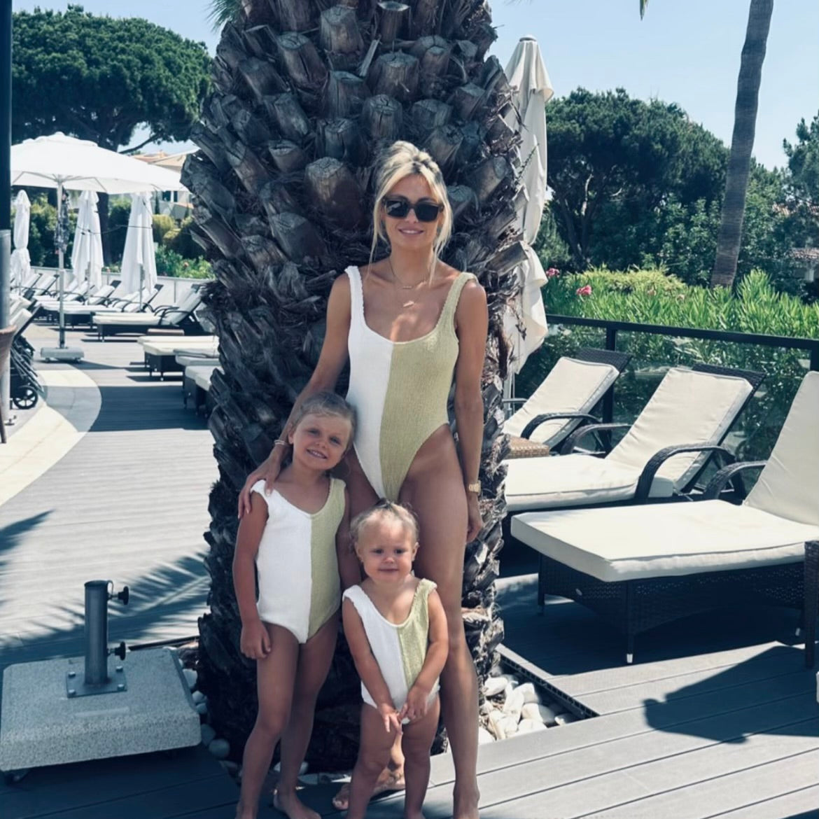 Mum and daughters wearing signature block matching crinkle swimsuits on holiday