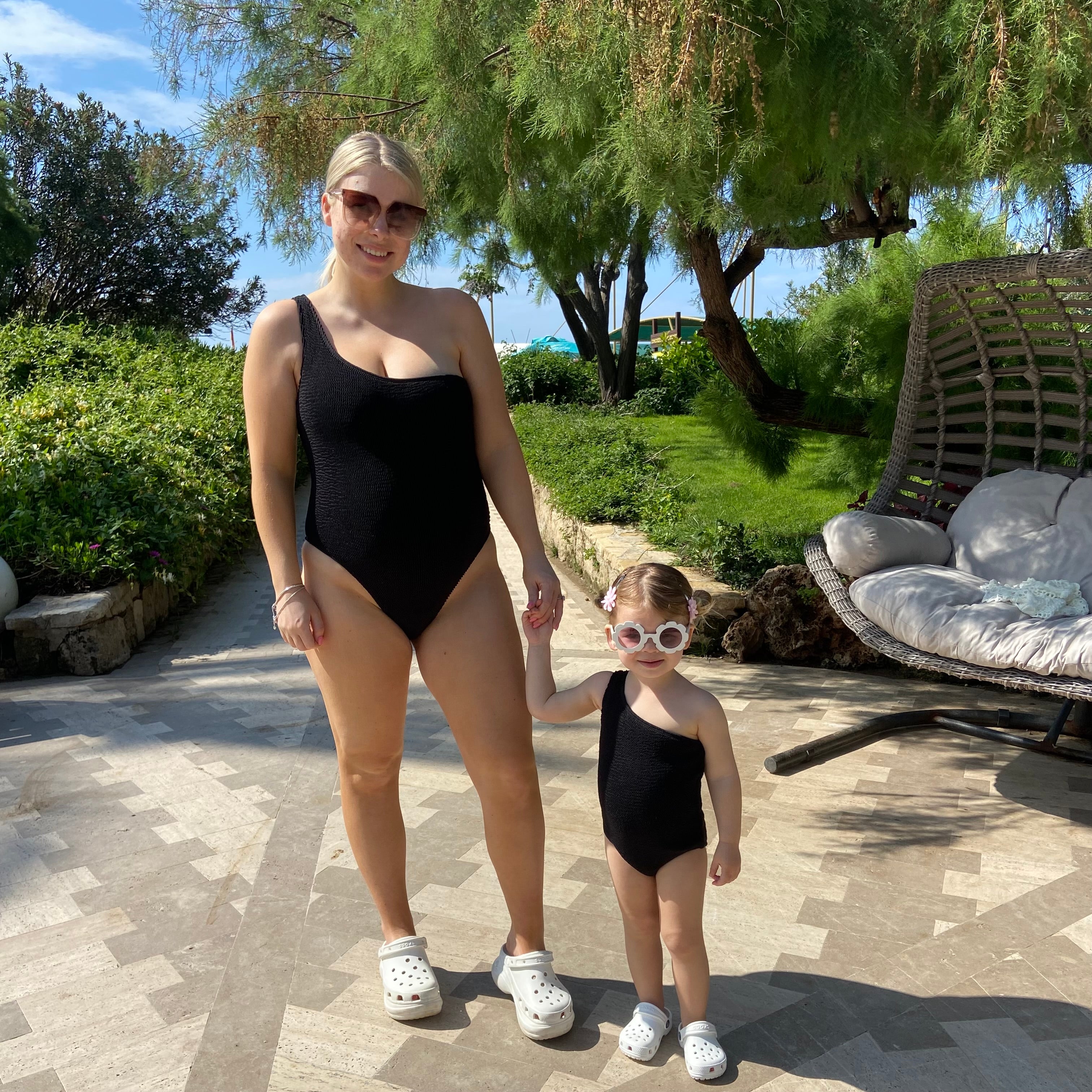 Matching mum and daughter matching in black one strap crinkle swimsuits